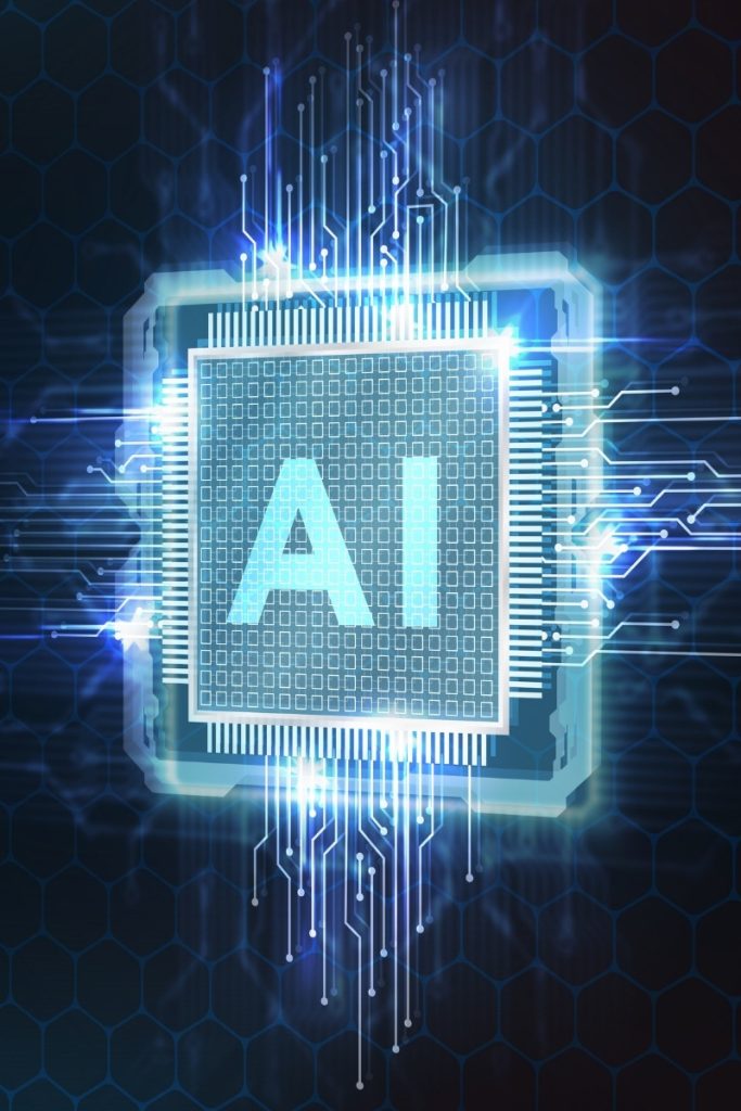 Glowing electronic chip bearing AI letters